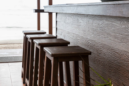 Empty Tall brown wood chair Placed at the bar counter by the seaの写真素材