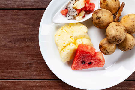 Mixed fruit plate on white brown tableの写真素材
