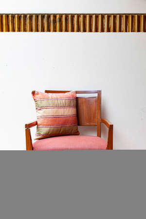 Brown wooden chairs and brown cushions on the balconyの写真素材