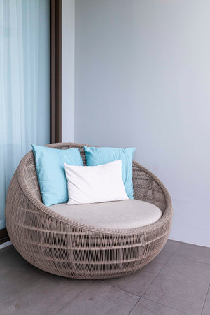 Empty brown plastic rattan sofa on the balcony of the houseの写真素材