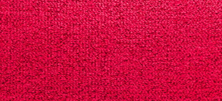 Panorama of Factory fabric of red color . Close-up long and wide texture of natural red fabric. Fabric texture of natural cotton or linen textile material. Red canvas backgroundの写真素材
