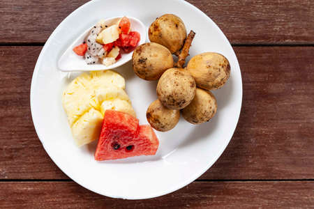 Mixed fruit plate on wood brown tableの写真素材