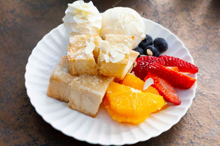 Stack of french toast with cottage cheese, honey and strawberries for breakfastの写真素材