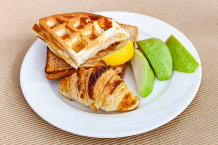 Western breakfast set plate, croissant, toast and fresh fruitの写真素材