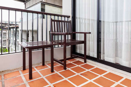 Brown wooden chairs and brown wood table on the balconyの写真素材