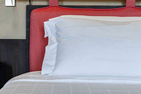 Close - up big white pillows on white bedの写真素材