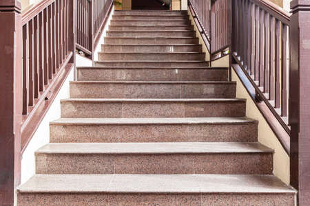 Building exterior stairs with antique red brown granite tilesの写真素材