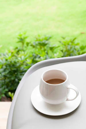 The coffee mug placed on brown wood tableの写真素材