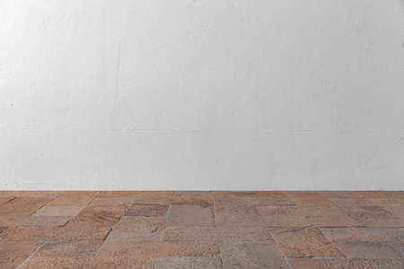 Brown rough granite surface and blank white exterior cement wall background seamlessの写真素材