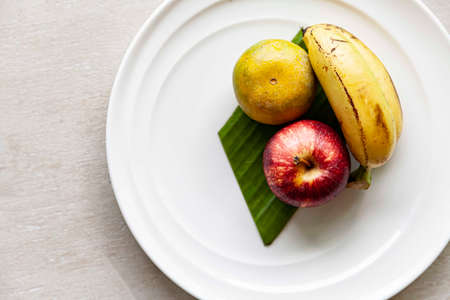 Mixed fruit plate on white wood tableの写真素材