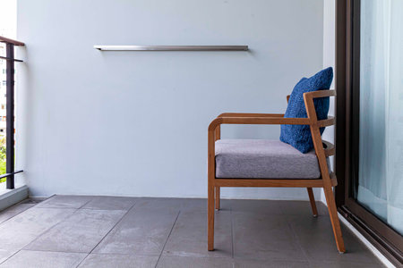 Brown wooden chairs and blue cushions on the balconyの写真素材