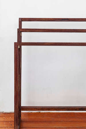 Brown wooden clothes rack placed in front of the houseの写真素材