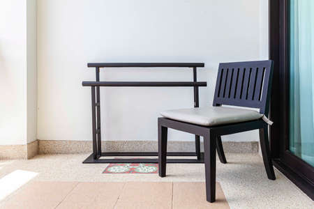 Empty dark brown wooden chairs and on the balconyの写真素材