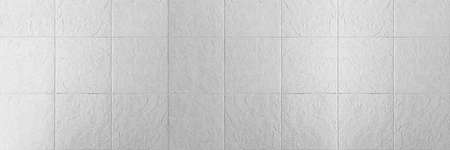 Panorama of White rough surface granite wall tiles pattern texture and background seamlessの写真素材