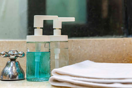 Clear plastic bottles for shampoo and body wash in the showerの写真素材