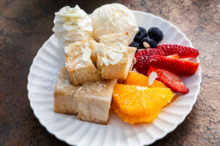 Stack of french toast with cottage cheese, honey and strawberries for breakfastの写真素材