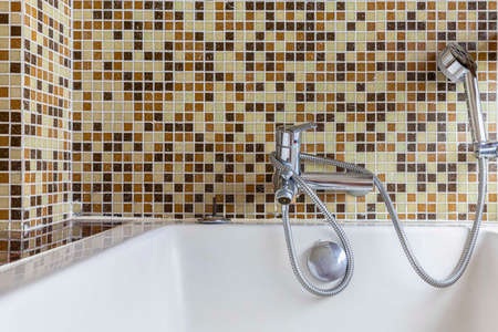 Bath tub in a small bathroom at the apartmentの写真素材