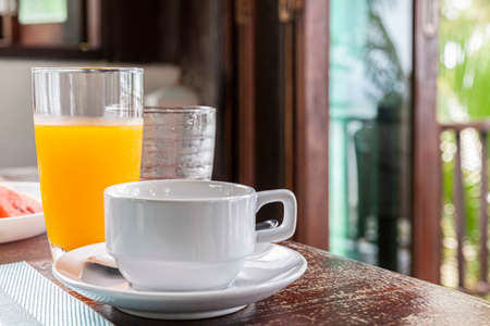 The coffee mug placed on the brown wood tableの写真素材