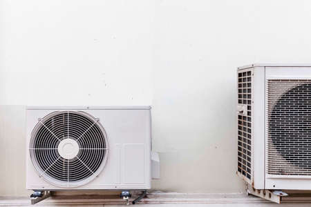 Air conditioner compressor outdoor unit installed outside the buildingの写真素材