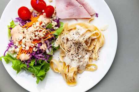 Western breakfast plate, salad, pasta and hamの写真素材