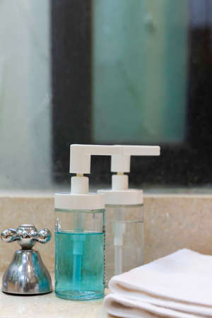 Clear plastic bottles for shampoo and body wash in the showerの写真素材