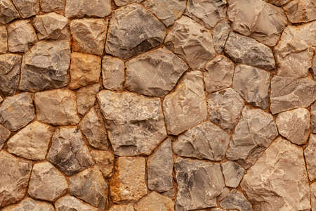 Brown natural stone wall pattern and background textureの写真素材
