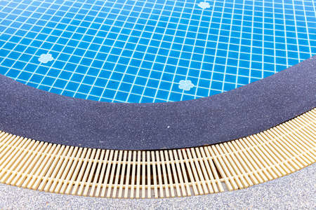 Wide swimming pool and brown stone floor inside the villaの写真素材