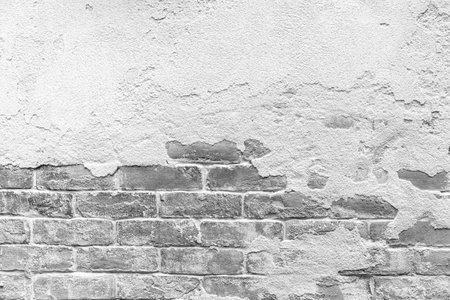 Old cement wall painted white, peeling paint texture and backgroundの写真素材