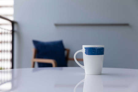 The coffee mug placed on the white wood tableの写真素材