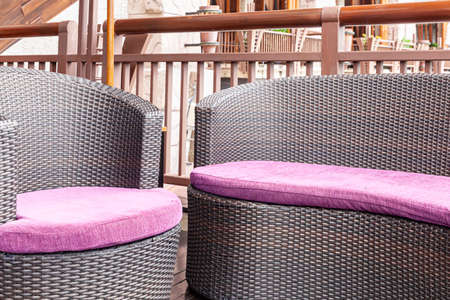 Purple cushions on a brown fabric long sofa in a modern home living roomの写真素材