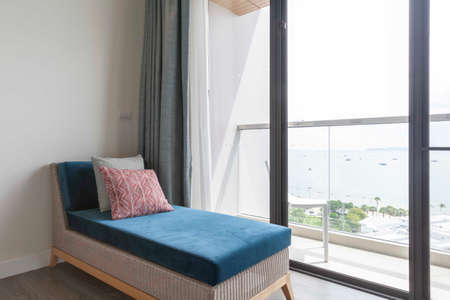 Rattan sofa and blue fabric bed For sleeping in the living room at homeの写真素材