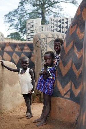 Tiebele,Burkina Faso - August 10,2009 : Gourounsi children are watching us on the visit of the village,are built with high walls to protect themselves from rival attacks.のeditorial素材