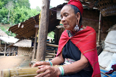 Mae Hong Son,Thailand - August 18,2005 : Women's Karen playing the instrument, the Karen ethnic...