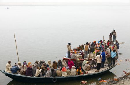 Varanasi,India - January 2,2010 : boats full of people, thousands of people arrive and leave each day by the river Ganges in Varanasi.のeditorial素材