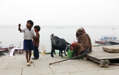 Varanasi,India - January 2,2010 : Children playing with a kite on the banks of the Ganges, the favorite game of children across India.のeditorial素材