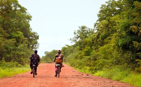 Tiebele, Burkina Faso - August 11, 2009: Family African cycling, the bicycle is the popular Means of transport,のeditorial素材