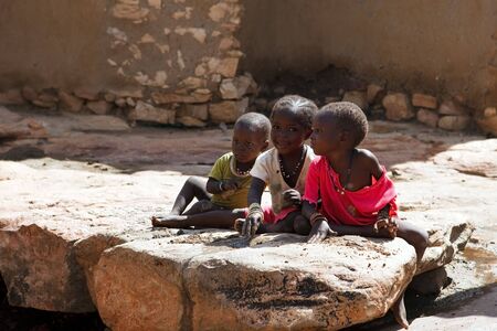 Dogon Country, Mali - August 19.2009: Children of the Dogon ethnic group playing with the mud, the Dogon are mainly farmers and blacksmiths and the majority living in the region of Bandiagaraのeditorial素材
