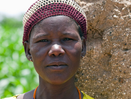 Country Bissa, Burkina Faso - August 9, 2009: Woman posing Bissa ethnic group, ethnic women working in the field Bissa growing millet and sorghumのeditorial素材