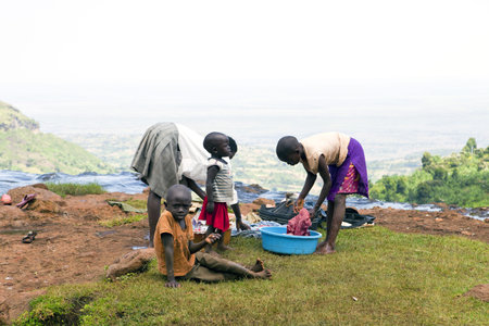 UGANDA-AUGUST 8: Women doing the laundry in the river Sipi, lack of running water in homes forcing women to perform domestic chores in the rivers, August 8, 2010 in Kapchorwe District, Ugandaのeditorial素材
