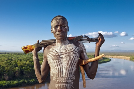 omo walley, ethiopia, august 13, 2011 - man of the karo ethnic group posing with his rifle.のeditorial素材