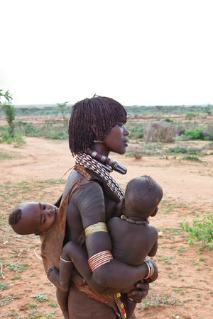 omo valley, ethiopian - august 15, 2011: women of ethnic hamer with their children in the village, the omo valley ethnic groups could disappear with the construction of gibe iii hydroelectric dam.のeditorial素材