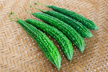 Bitter gourd on bamboo texture の写真素材