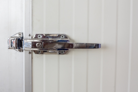 Aluminium door knob on the white door の写真素材