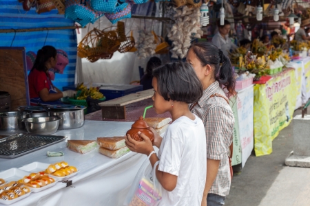 CHIANG MAI THAILAND JUNE 13: Girls waiting to buy local market on june 10,2013 in Chiang mai,Thailand.のeditorial素材