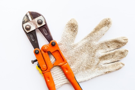 Wrench and gloves on white background の写真素材