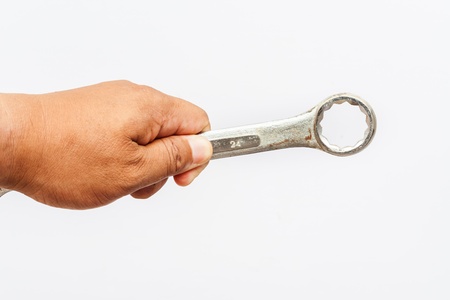 Hand and wrench on white background の写真素材