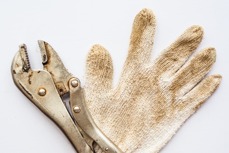 Wrench and gloves on white background の写真素材