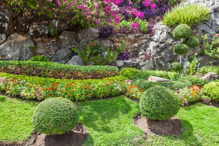 Colourful Flowerbeds and Winding Grass Pathway in an Attractive Thailand Formal Gardenの写真素材