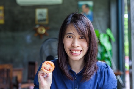 Beautiful thailand Woman Eating Salad At Homeの写真素材