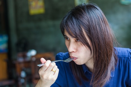 Beautiful thailand Woman Eating Salad At Homeの写真素材